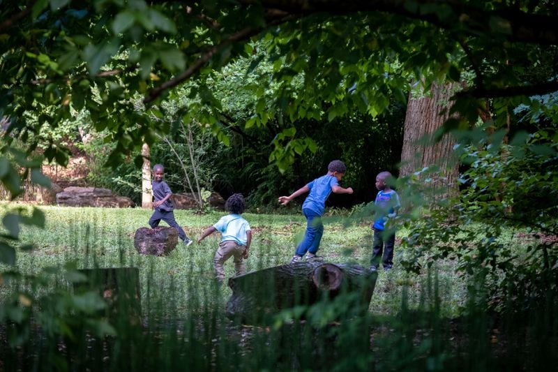Children from Gather Forest School learn and play at a park in Atlanta on Thursday, June 30, 2022. (Arvin Temkar / arvin.temkar@ajc.com)
