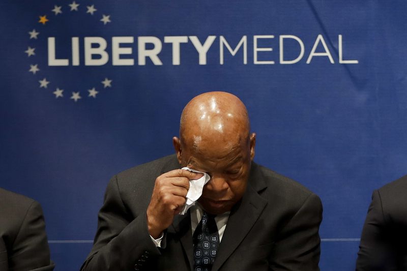 Rep. John Lewis, D-Ga., wipes his face during a ceremony where he was being presented with the Liberty Medal for his dedication to civil rights at the National Constitution Center, Monday, Sept. 19, 2016, in Philadelphia. The honor is given annually to an individual who displays courage and conviction while striving to secure liberty for people worldwide. (AP Photo/Matt Slocum)