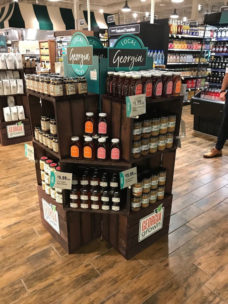 Free-standing store displays like this one at the Fresh Market showcase local Georgia products, such as Georgia Grinders nut butters, Ziegler’s honey and Pride Road hibiscus products. CONTRIBUTED BY THE FRESH MARKET