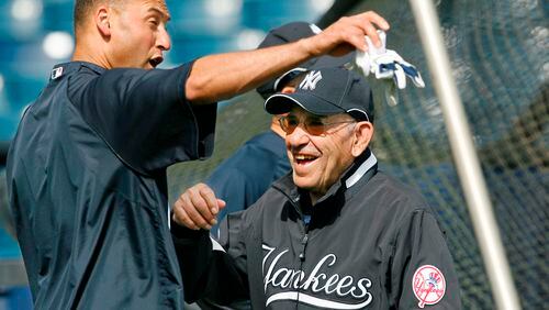 This March 7, 2008, file photo shows New York Yankees shortstop Derek Jeter, left, and Yogi Berra clowning around by the batting cage before the Yankees spring training baseball game against the Houston Astros at Legends Field in Tampa. Berra, the Yankees Hall of Fame catcher, has died. He was 90.