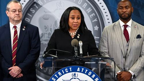 
                        FILE  — Fulton County District Attorney Fani Willis holds a press conference to announce the indictment of former President Donald Trump and others, in Atlanta on Aug. 14, 2023. Fani Willis, center, is accused of having a romantic relationship with Nathan Wade, right, a special prosecutor she had hired. (Kenny Holston/The New York Times)
                      