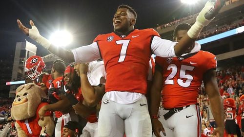 November 18, 2017 Athens: Georgia senior linbacker Lorenzo Carter and teammates celebrate a 42-13 victory over Kentucky with fans in a NCAA college football game on Saturday, November 18, 2017, in Athens.    Curtis Compton/ccompton@ajc.com