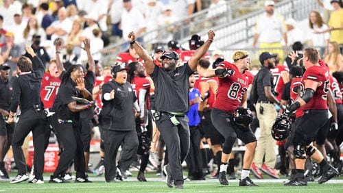 Northern Illinois players and coaching staff celebrate after Northern Illinois wide receiver Tyrice Richie (3) made the game-winning catch during the second half Saturday, Sept. 4, 2021, at Bobby Dodd Stadium in Atlanta. (Hyosub Shin / Hyosub.Shin@ajc.com)