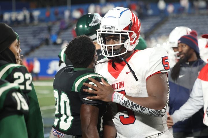 Milton running back Jordan McDonald (5) greets Collins Hill players after Milton's loss to Collins Hill in the Class 7A state title football game at Georgia State Center Parc Stadium Saturday, December 11, 2021, Atlanta. JASON GETZ FOR THE ATLANTA JOURNAL-CONSTITUTION