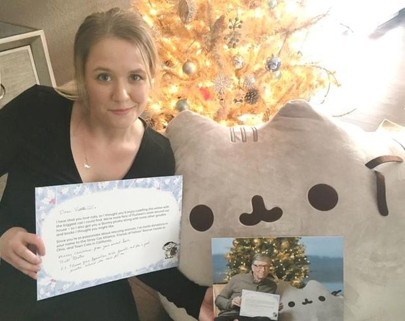 Reddit user and cat lover Megan Cummins received quite the gift from tech billionaire Bill Gates. She’s posing here with the letter, photograph and giant stuffed Pusheen cat Gates sent her for Christmas.