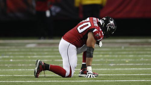 Atlanta Falcons tackle Jake Matthews (70) kneels on the turf after injury against the Kansas City Chiefs during the first half of an NFL football game, Sunday, Dec. 4, 2016, in Atlanta. (AP Photo/John Bazemore)