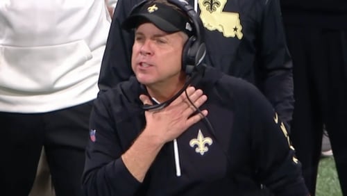 New Orleans Saints coach Sean Payton makes the "choke" sign during a game with the Atlanta Falcons.