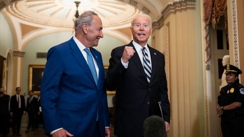 Senate Majority Leader Chuck Schumer (D-NY) and U.S. President Joe Biden speak briefly to reporters as they arrive at the U.S. Capitol for a Senate Democratic luncheon July 14, 2021 in Washington, DC. President Biden is on the Hill to discuss with Senate Democrats the $3.5 trillion reconciliation package they have reached overnight that would expand Medicare benefits, boost federal safety net programs and combat climate change. (Drew Angerer/Getty Images/TNS)