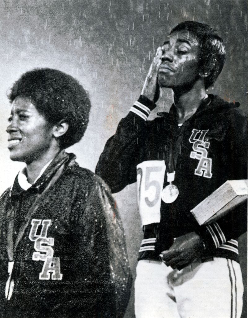 Her gold medal in place, Wyomia Tyus brushes away rain and tears. Miss Tyus' teammate, Barbara Ferrell (left), second in 100 meters for USA. (UPI) 1968