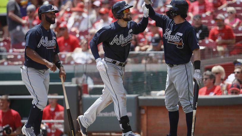 Danny Santana (left) went 4-for-5 with two doubles and a home run Sunday, and Ender Inciarte (center) had five hits including a homer in the Braves' 13-8 slugfest win at Cincinnati. (AP Photo/John Minchillo)