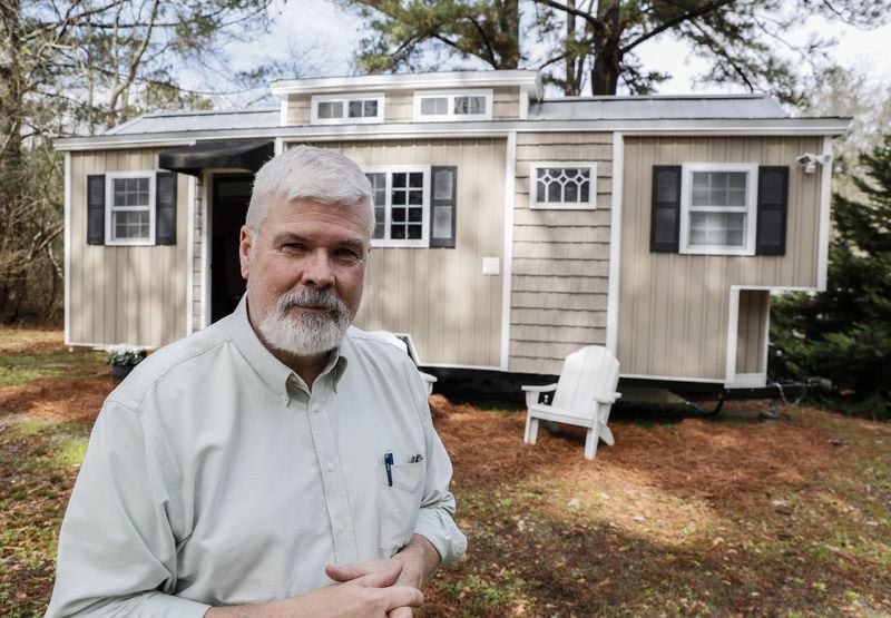 Larry Singleton stands in front of his custom tiny home. Bob Andres / bandres@ajc.com
