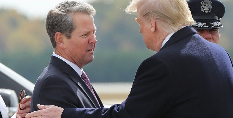 Georgia Gov. Brian Kemp, left, greets President Donald Trump as he arrives at Dobbins AFB in Marietta in November 2019. Trump accused Kemp of disloyalty for not helping in an effort to overturn the results of the 2020 presidential election in Georgia. Their relationship remains strained after Trump backed a Kemp opponent in the 2022 GOP primary. (Curtis Compton/Atlanta Journal-Constitution/TNS)