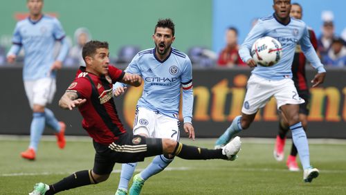 Atlanta United midfielder Carlos Carmona, left, of Chile defends New York City FC forward David Villa (7) of Spain center as New York City FC Rodney Wallace watches, right, during the first half of an MLS soccer game, Sunday, May 7, 2017, in New York. (AP Photo/Kathy Willens)