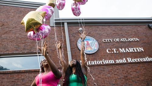 Lattice Bulger (right) and Jermiya Richardson (left) release their balloons during an event honoring shooting victim Bre'Asia Powell on Wednesday, May 31, 2023, at the C.T. Martin Natatorium and Recreation Center in Atlanta. Powell was killed on Memorial Day weekend at a gathering at Benjamin E. Mays High School, which she attended. CHRISTINA MATACOTTA FOR THE ATLANTA JOURNAL-CONSTITUTION.