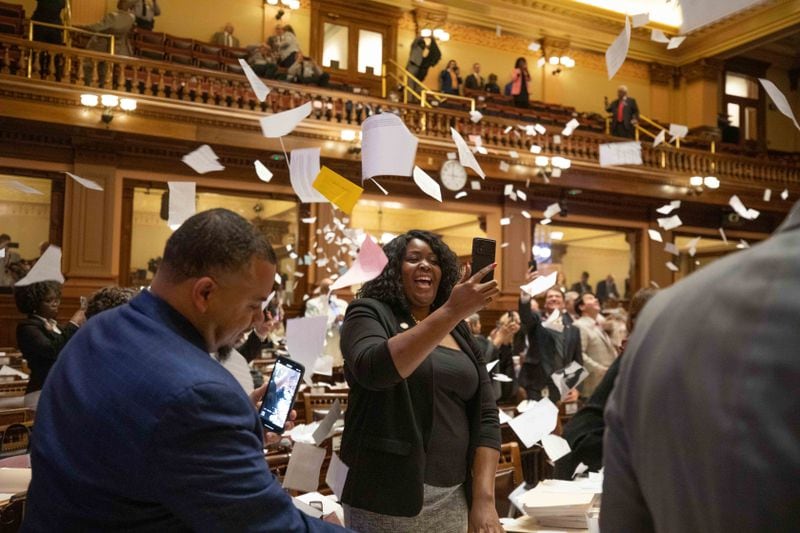 House members throw up paper at the conclusion of the legislative session in the House Chamber on Sine Die, the last day of the General Assembly at the Georgia State Capitol in Atlanta on Tuesday, April 5, 2022.   Branden Camp/ For The Atlanta Journal-Constitution