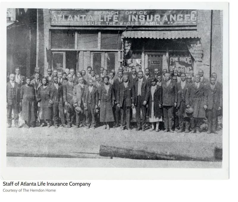 In this undated photograph, the staff of the Atlanta Life Insurance Company poses in front of the building located at 229 Auburn Ave.