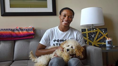 When off the court, Connecticut Sun guard Jasmine Thomas enjoys creating art, candle making, cooking, and fussing over her dogs, including 8-month-old Toy Poddle Oliver, at home in Taftville, Conn. (John Woike/Hartford Courant/TNS)