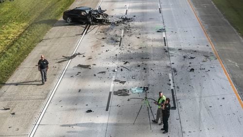 August 9, 2023 Clayton County: One person is dead after a driver sped away from an off-duty officer in the wrong direction on I-675 South and crashed into three other vehicles Wednesday morning, Aug. 9, 2023. Clayton County police have shut down the interstate to investigate the crash, which happened around 6:30 a.m. near the Forest Parkway exit in Ellenwood. Commuters are urged to avoid the area as the investigation is likely to span “multiple hours,” a spokesperson for the department said. Mangled vehicles and debris are scattered across all three lanes, including a wheel that landed in the grass next to a teddy bear. Police said an off-duty officer was on his way home, heading south on I-675, when he saw a vehicle stopped in the grassy median. It appeared the driver had been traveling north and left the road. When the officer approached, he saw the driver “passed out behind the wheel,” police said. The officer then knocked on the window and woke the driver, who “appeared to be incoherent with glassy eyes and sweating.” The driver was asked multiple times to open the door, but instead sped off in the wrong direction, according to police. By the time the officer got back to his patrol car, he could no longer see the vehicle. After driving about a mile down the interstate, the officer came upon the wreckage that spanned all three lanes of the interstate. The driver he encountered had crashed into three other vehicles. Another driver was killed, according to police, and has yet to be identified. Officials said it is unclear if the fleeing driver was impaired or experiencing a medical emergency. No other details were released about the crash, including the condition of the alleged wrong-way driver or the survivors in the other vehicles. The front end of a sedan was crushed, as was an SUV that also sustained severe damage to its side. (John Spink / John.Spink@ajc.com)


