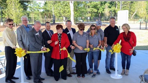 Gwinnett Commission Chairman Charlotte Nash, center, is joined by county and other officials during a ribbon-cutting celebrating a $5.6 million expansion project at Rock Springs Park.