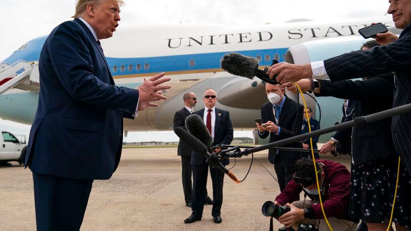 President Donald Trump talks to reporters before boarding Air Force One for a trip to Phoenix to visit a Honeywell plant that manufactures protective equipment.
