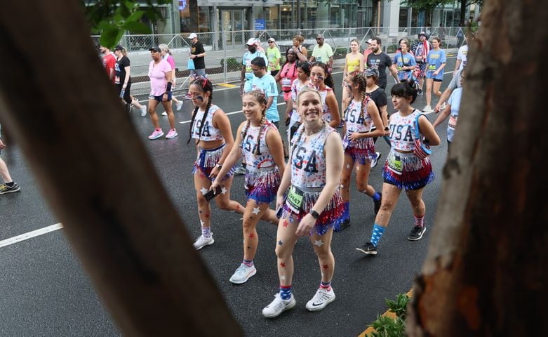 Costumed runners stroll along the course during the 54th running of The Atlanta Journal-Constitution Peachtree Road Race on Tuesday, July 4th, 2023.   (Arvin Temkar / Arvin.Temkar@ajc.com)