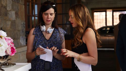 Westminster grad Sallie Patrick (left) runs "Dynasty" on the CW. Here, she consults with star Elizabeth Gillies, who plays Fallon Carrington. CREDIT: the CW