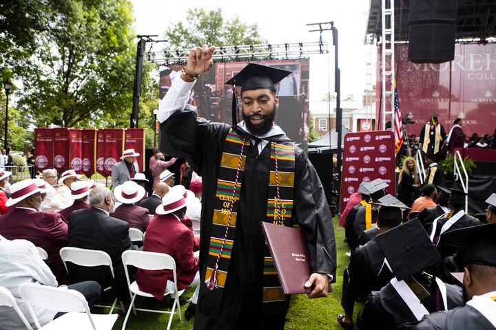 Tim Livingston walk back toward his seat with his degree during the Morehouse College commencement ceremony on Sunday, May 21, 2023, on Century Campus in Atlanta. The graduation marked Morehouse College's 139th commencement program. CHRISTINA MATACOTTA FOR THE ATLANTA JOURNAL-CONSTITUTION