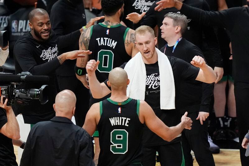 The Boston Celtics celebrate at the end of of Game 4 of an NBA basketball first-round playoff series against the Miami Heat, Monday, April 29, 2024, in Miami. (AP Photo/Marta Lavandier)