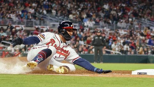 Atlanta Braves left fielder Eddie Rosario canÕt make it to first in time during a game against Cincinnati Reds at Truist Park on Saturday, April 9, 2022, in Atlanta.  Branden Camp/For the Atlanta Journal-Constitution