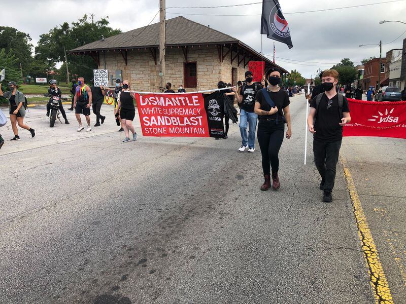 Saturday, Aug. 15, 2020, Stone Mountain -- Counter-protesters march down Main Street chanting and carrying banners.