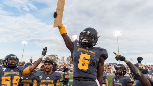 Kennesaw State's Akebren Ralls (6) lifts the "turnover plank" after a pick-six in Saturday's first-round FCS playoff game between Kennesaw State and Samford, Saturday, Nov. 25, 2017. (Special by Cory Hancock)