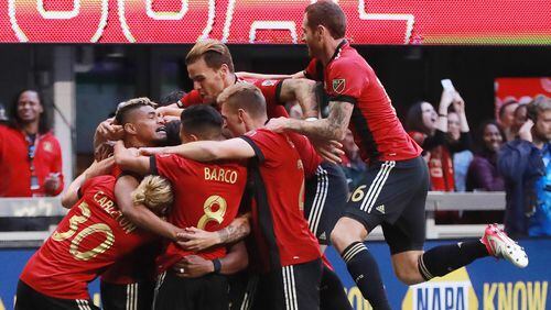 Atlanta United players mob Franco Escobar after his goal for a 1-0 lead over the Chicago Fire during the first half in a MLS soccer match on Sunday, Oct 21, 2018, in Atlanta.   Curtis Compton/ccompton@ajc.com