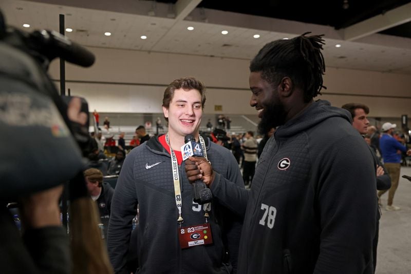 Georgia defensive lineman Nazir Stackhouse, right, interviews long snapper William Mote for a local television station during Georgia’s media day at the Los Angeles Convention Center, Sat., Jan. 7, 2023, in Los Angeles, Ca. Georgia plays TCU for the 2023 College Football Playoff National Championship Mon. Jan. 9, 2023, at SoFi Stadium.  (Jason Getz / Jason.Getz@ajc.com)