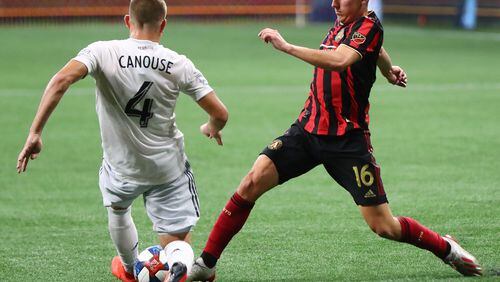 July 21, 2019 Atlanta: Atlanta United midfielder Emerson Hyndman works the ball between the legs of D.C. United midfielder Russell Canouse in a soccer match on Sunday, July 21, 2019, in Atlanta.   Curtis Compton/ccompton@ajc.com