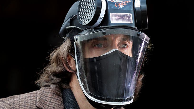 Ryan Proffitt, a 39-year-old language arts teacher at Lanier High School in Gwinnett who is suffering from long-term effects of COVID-19, wears a N-95 battery powered respirator in and out of the classroom on Feb.1, 2021, in Sugar Hill.  (Curtis Compton / Curtis.Compton@ajc.com)