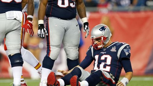New England Patriots quarterback Tom Brady (12) lies on the field after being sacked in the fourth quarter against the Kansas City Chiefs at Gillette Stadium.