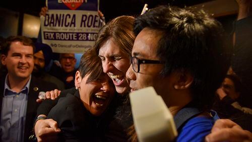 Danica Roem, center, a Democrat who ran for Virginia's House of Delegates against GOP incumbent Robert Marshall, is greeted by supporters as she prepares to give her victory speech Tuesday, Nov. 7, 2017, in Manassas, Va. Roem, a former journalist, is set to make history as the first openly transgender person elected and seated in a state legislature in the United States.