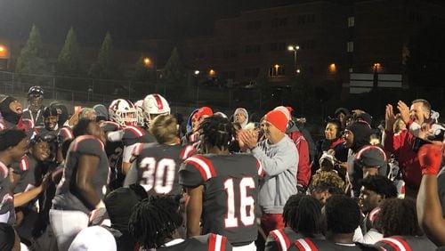 Archer coach Andy Dyer congratulates his team after its 9-0 win over Norcross on Friday, Nov. 5. The victory gave the Tigers the Region 7-7A championship.