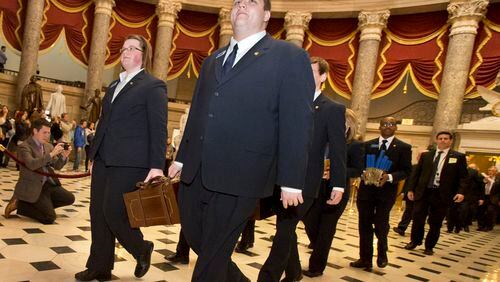 IT'S OFFICIAL--Pages lead a Senate procession carrying two boxes holding Electoral College votes through Statuary Hall to the House Chamber on Capitol Hill on Capitol Hill in Washington, Friday, Jan. 4, 2013, for the counting of the votes in the presidential election. A tally of the U.S. Electoral College vote affirmed President Barack Obama's re-election. (AP Photo/Jacquelyn Martin)
