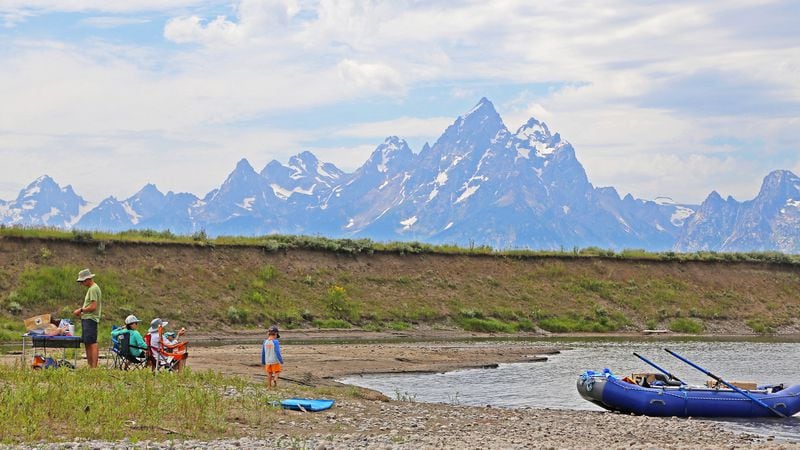 A family of rafters takes a lunch break while drifting on the Snake River in Grand Teton National Park. (Dennis Anderson/Minneapolis Star Tribune/TNS)
