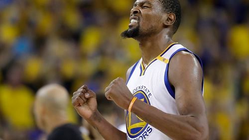 Golden State Warriors forward Kevin Durant reacts after scoring against the Cleveland Cavaliers during the second half of Monday’s Game 5 of the NBA Finals. (AP Photo/Marcio Jose Sanchez)