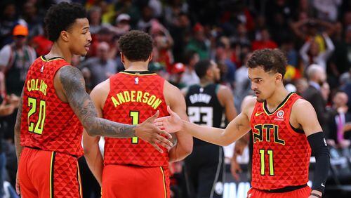 Atlanta Hawks guard Trae Young is congratulated by teammate John Collins after hitting a shot in overtime against the Milwaukee Bucks Sunday, March 31, 2019, at StateFarm Arena n Atlanta.