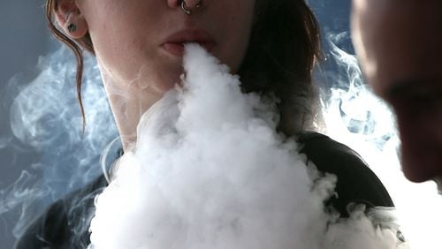 A girl smokes an e-cigarette. A new study recorded a dramatic uptick in the numbers of teenagers vaping nicotine in the past year. Experts are worried about the health affects.