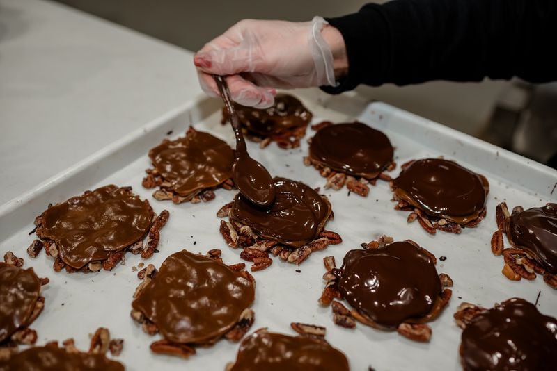 Janna Tucker's version of turtles, named Ruckus Makers, have chocolate and soft caramel drizzled over pecan pieces. Courtesy of Julie Freeman Photography