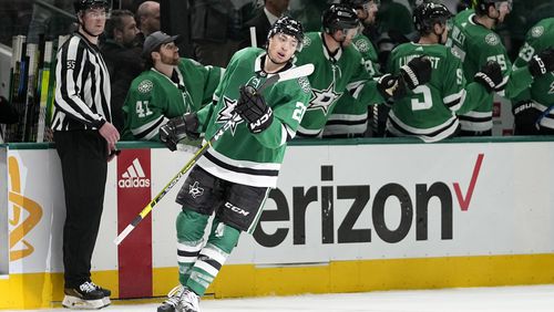 Dallas Stars' Jason Robertson celebrates his goal with the bench in the second period in Game 5 of an NHL hockey Stanley Cup first-round playoff series against the Vegas Golden Knights in Dallas, Wednesday, May 1, 2024. (AP Photo/Tony Gutierrez)