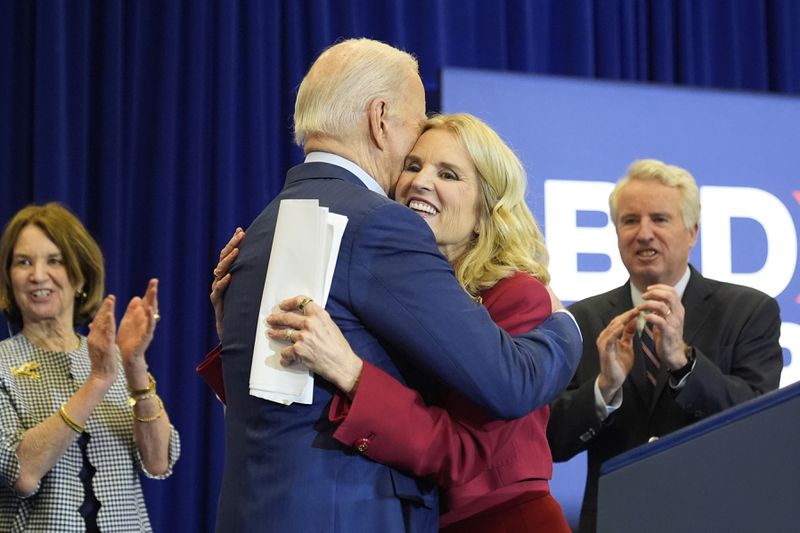 Kerry Kennedy, right, hugs President Joe Biden at a campaign event, Thursday, April 18, 2024, in Philadelphia. Pictured from left are members of the Kennedy family Kathleen Kennedy Townsend and Christopher Kennedy. (AP Photo/Alex Brandon)