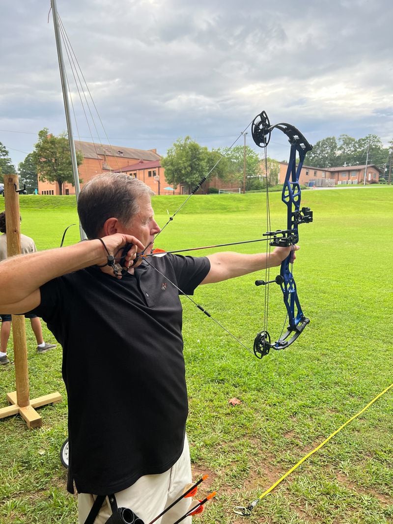 Ken Tromer draws back on his compound bow.