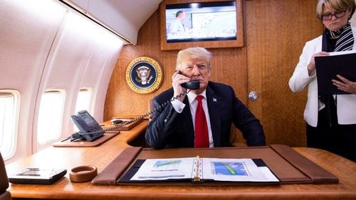 President Donald Trump, joined by National Security Council Deputy Chief of Staff Joan O’Hara,  talks to Gov. Nathan Deal about Hurricane Michael aboard Air Force One on Oct. 10, 2018. (Official White House Photo by Joyce N. Boghosian)