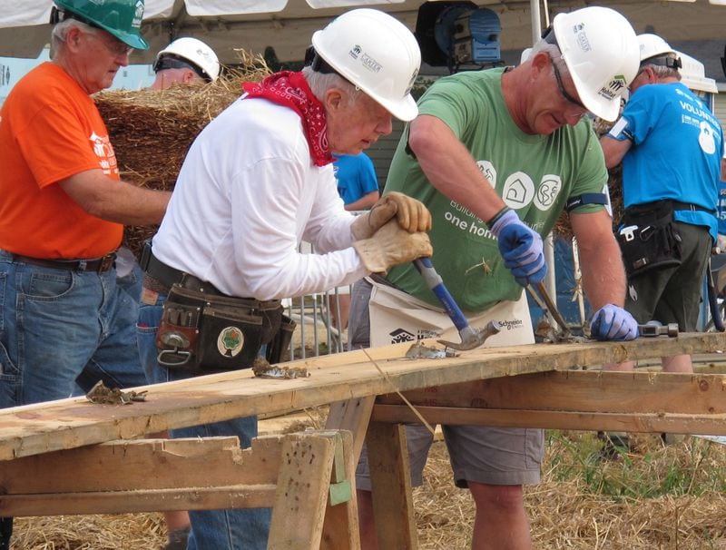 Former President Jimmy Carter, center, works on a Habitat for Humanity construction project on Monday, Aug. 22, 2016 in Memphis, Tenn. On Monday, Carter said he thought he had just a few weeks to live during his battle with cancer a year ago. "Now I feel pretty certain about my cure and the cancer being in remission, but the doctors are still keeping an eye on me," he said. (AP Photo/Adrian Sainz)