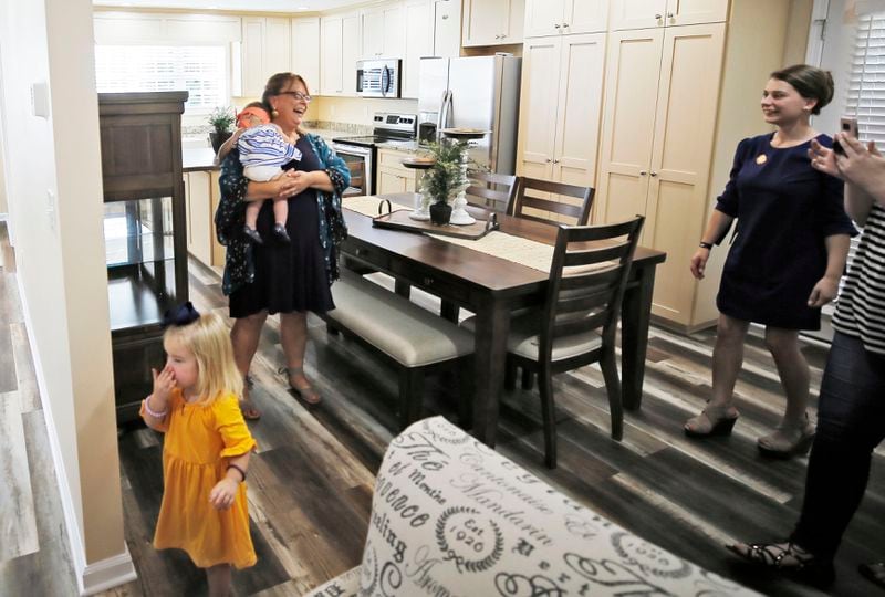 9/11/18 - Barnesville - Sarah Schaaff tours the house with her mom, Ariyl  Fueuntes, and daughters Guinevere and Willow (left).  On Tuesday morning in Barnesville, a charity started in honor of a fallen 9/11 firefighter gave a home to the wife and young daughters of Marine Cpl. Collin Schaaff, who has one of 16 who lost their lives last year in a transport plane crash in Mississippi. "Stephen Siller lost his life protecting others on 9/11 and Cpl. Schaaff was killed in the line of duty protecting all Americans, Òsaid Frank Siller, Chairman and CEO of the Tunnel to Towers Foundation. ÒIf it weren't for the attacks on the World Trade Center, Cpl. Schaaff would not have been in harmÕs way, and would still be here to be a husband and father.Ó   BOB ANDRES  /BANDRES@AJC.COM